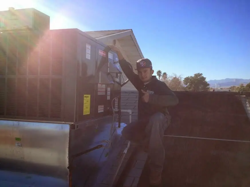 HVAC technician performing HVAC Inspection on a rooftop unit in Bailey's Crossroads